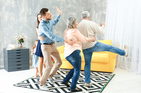 Happy big family dancing in the roomの写真素材