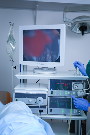 Doctor adjusting special equipment in operating room