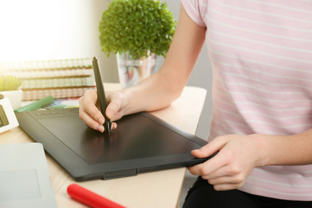 Young designer drawing sketches on graphic tabletの写真素材