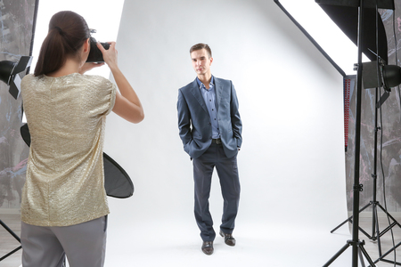 Photographer working with model in studioの写真素材
