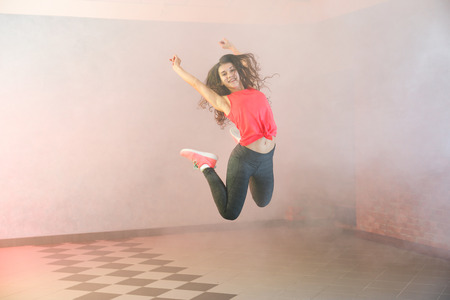 Beautiful young hip-hop dancer in studioの写真素材