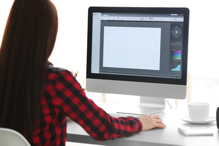 Young female designer working in officeの写真素材