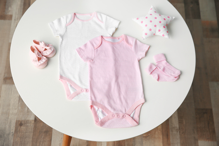 Set of baby clothes on light tableの写真素材