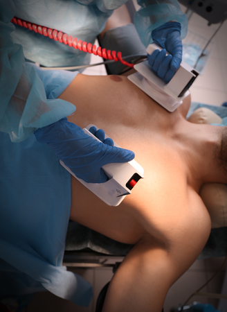 Doctor trying to save patient's life in clinicの写真素材