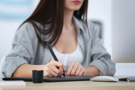 Young female designer working in officeの写真素材