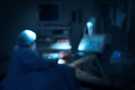 Operating of patient in modern clinic, blurred viewの写真素材