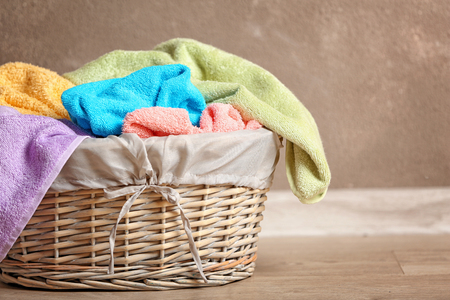 Flasket of dirty towels on light backgroundの写真素材