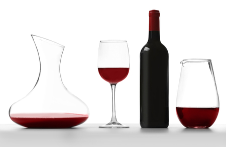 Glass carafe of red wine on white backgroundの写真素材