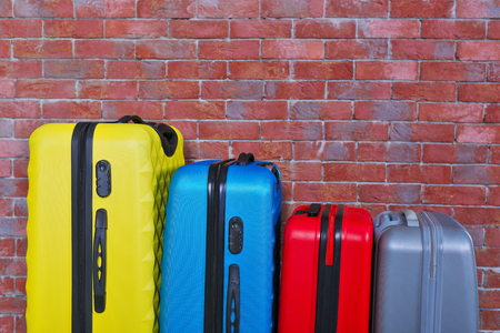 Color suitcases on brick backgroundの写真素材