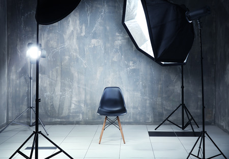 Modern photo studio interior with professional lighting equipmentの写真素材
