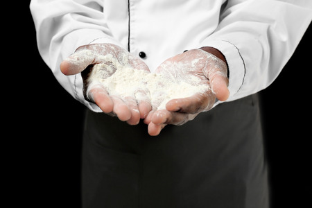 African American chef with flour on dark background, closeupの写真素材