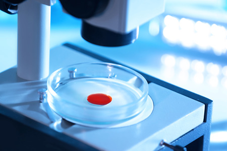 Microscope with chemical glassware in laboratoryの写真素材