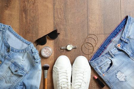 Flat lay set of female clothes and accessories on wooden backgroundの写真素材