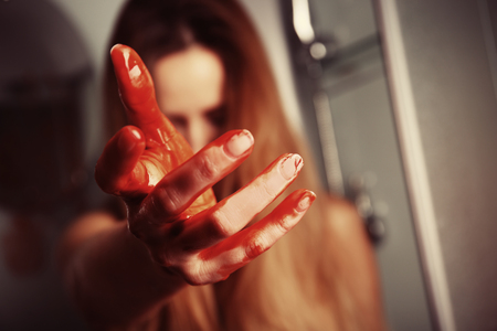 Woman with bloody hand in showerの写真素材