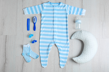 Baby clothes and accessories on wooden backgroundの写真素材