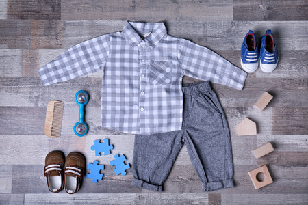 Baby clothes and accessories on wooden backgroundの写真素材