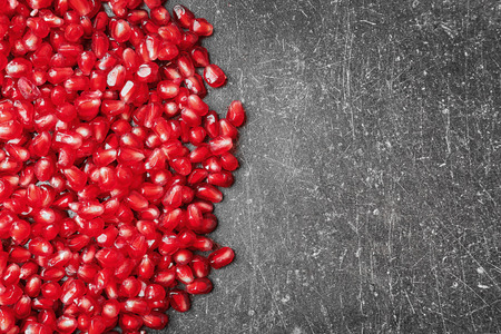 Pomegranate seeds on gray background, closeupの写真素材