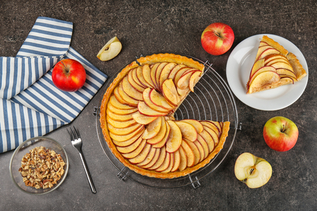 Metal stand with homemade apple pie on tableの写真素材