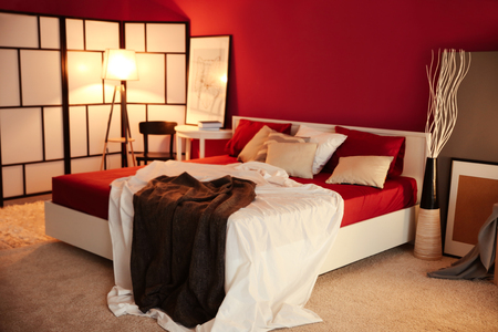 Interior of modern bedroom with cozy double bedの写真素材