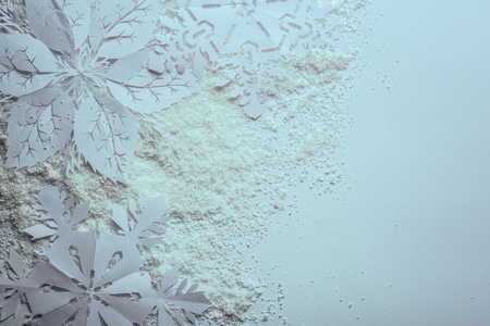 Beautiful paper snowflakes and snow on white backgroundの写真素材