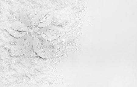 Beautiful paper snowflake and snow on white backgroundの写真素材
