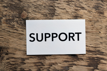 Word SUPPORT on wooden background