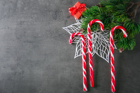 Christmas candy canes on grey textured background