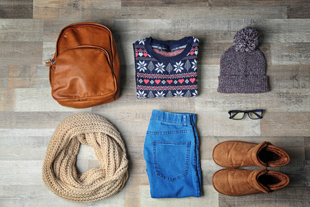 Set of female stylish clothes on wooden background