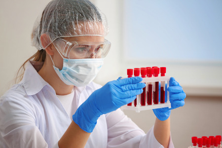Woman working with blood samples in laboratory