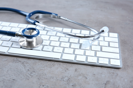 Stethoscope on computer keyboard, closeupの写真素材