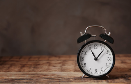 Alarm clock on wooden table
