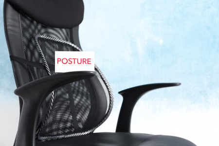 White paper with word POSTURE on black office chair
