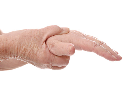 Hands of elderly woman suffering from pain in wrist on white background, closeupの写真素材