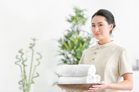 Young Asian masseur in spa salonの写真素材