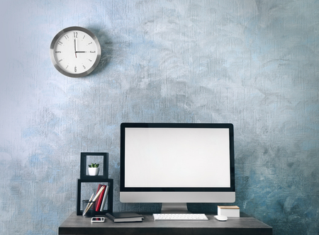 Workplace with computer on table in modern roomの写真素材