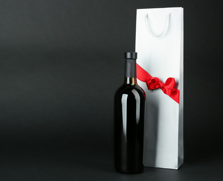 Wine bottle and gift bag on dark backgroundの写真素材