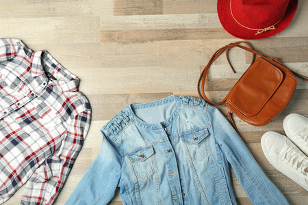 Set of stylish clothes and accessories on wooden backgroundの写真素材