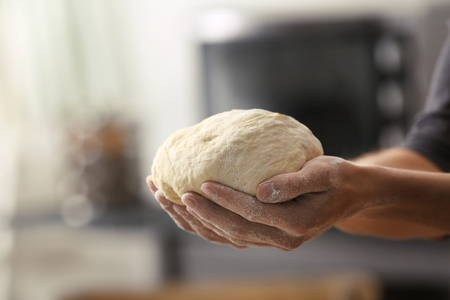 Hands holding dough ready for baking, closeupの写真素材