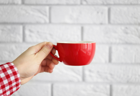 Blank red cup in hand, closeupの写真素材