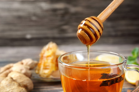 Hot drink with honey for cough remedy, closeupの写真素材
