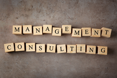 Wooden cubes with text MANAGEMENT CONSULTING on color backgroundの写真素材