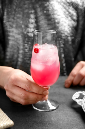 Woman with glass of delicious wine spritzer at tableの写真素材