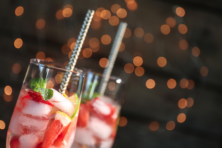 Glass of delicious wine spritzer on blurred lights backgroundの写真素材