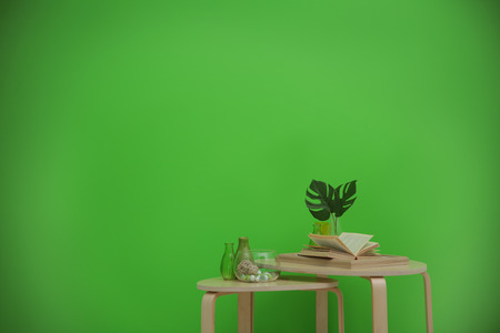 Tables with home decor on greenery wall backgroundの写真素材