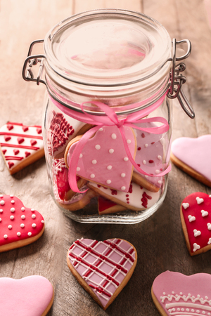 Valentine's day cookies in glass jar on wooden backgroundの写真素材
