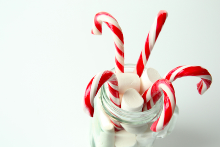 Christmas candy canes in jar on white backgroundの写真素材