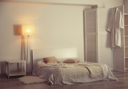 Interior of beautiful room with bed and folding screenの写真素材