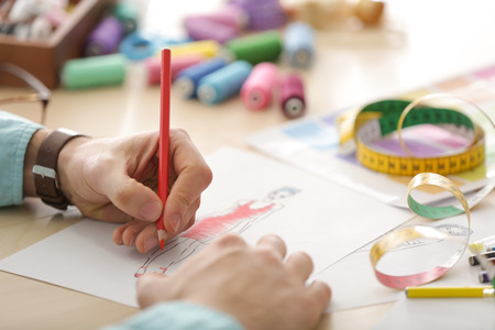 Young male fashion designer at workplace