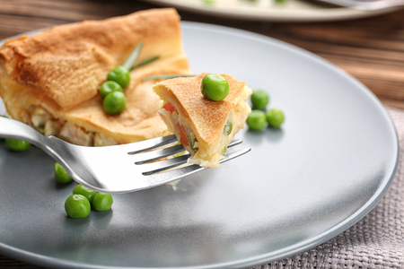 Piece of tasty chicken pot pie with green peas on plate, closeupの写真素材