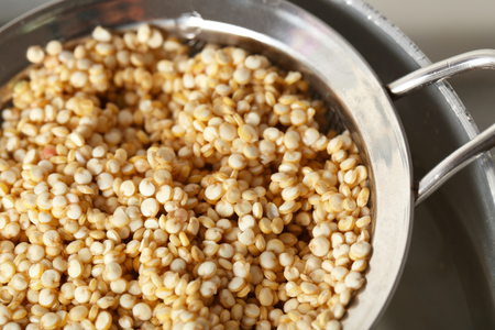 Sieve with quinoa seeds in saucepan, closeupの写真素材